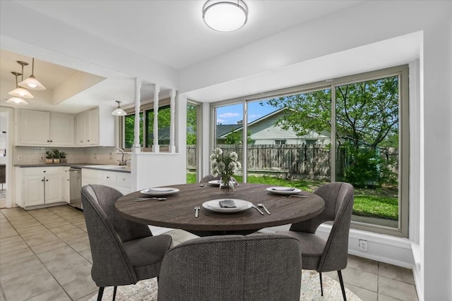 9010 Quail Creek Dr, Austin, TX 78758 - dining space featuring a raised ceiling and light tile patterned flooring