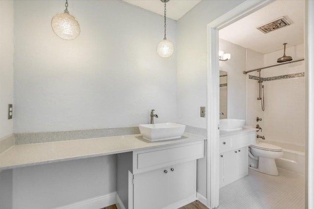 9010 Quail Creek Dr, Austin, TX 78758 - full bathroom featuring toilet, vanity, visible vents, and a combined bath / shower with rainfall shower