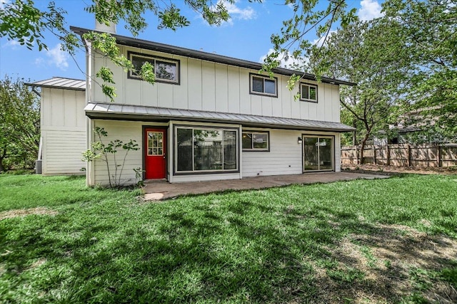 9010 Quail Creek Dr, Austin, TX 78758 - rear view of property with a lawn, a standing seam roof, fence, metal roof, and a patio