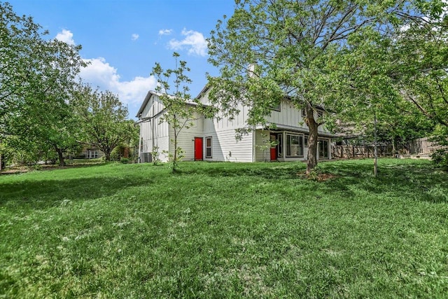 9010 Quail Creek Dr, Austin, TX 78758 - rear view of property featuring a lawn, fence, and board and batten siding