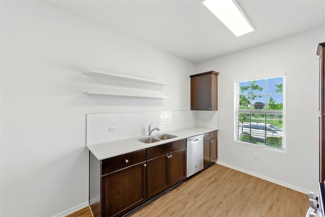 7013 Tonka Ln, Austin, TX 78744 - kitchen featuring a sink, dishwasher, open shelves, tasteful backsplash, and light wood finished floors