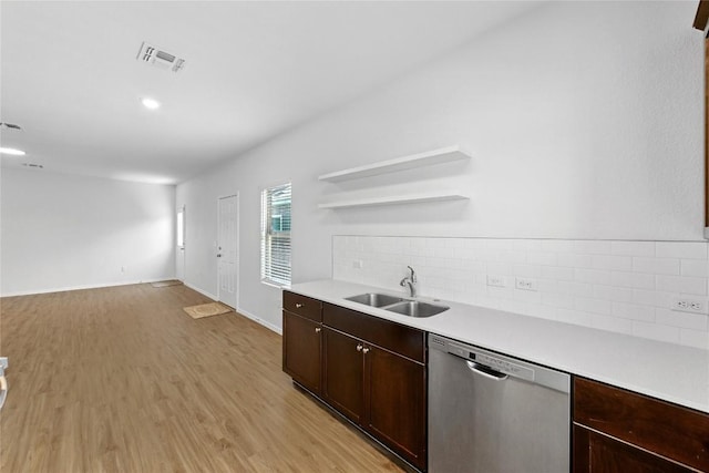 7013 Tonka Ln, Austin, TX 78744 - kitchen featuring dishwasher, a sink, open shelves, tasteful backsplash, and light countertops
