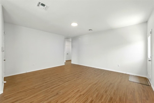 7013 Tonka Ln, Austin, TX 78744 - spare room featuring light wood-type flooring, baseboards, and recessed lighting