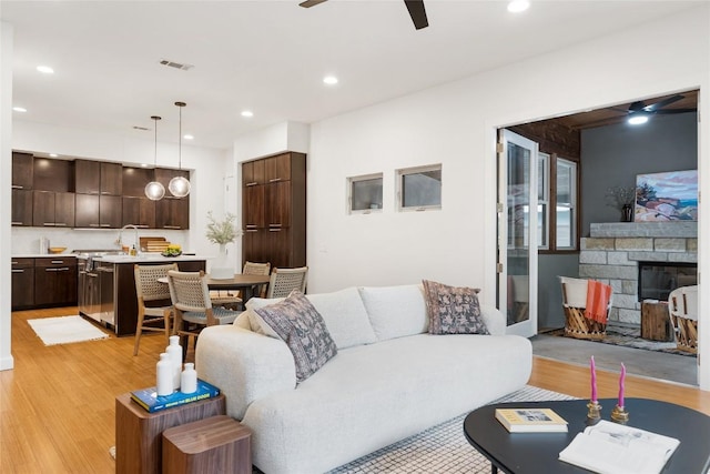 310 Terrace Dr Unit B, Austin, TX 78704 - living area featuring a ceiling fan, light wood-type flooring, recessed lighting, and a fireplace