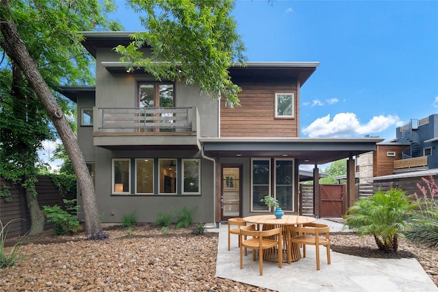 310 Terrace Dr Unit B, Austin, TX 78704 - rear view of house with a balcony, a patio area, stucco siding, fence, and a gate