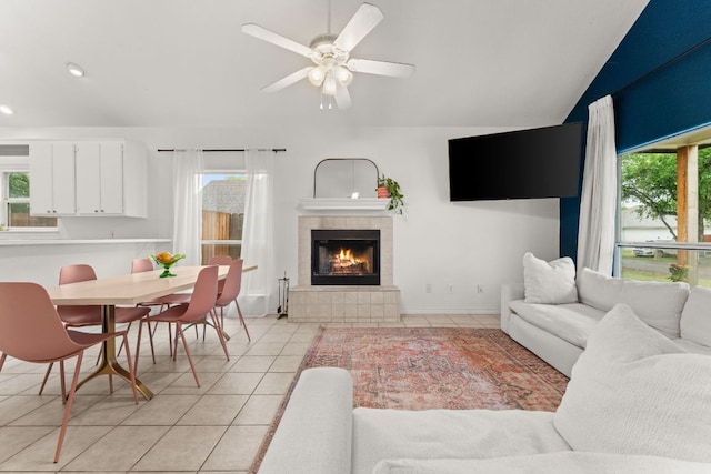 649 Aspen Ln, Cottonwood Shores, TX 78657 - living room featuring healthy amount of natural light, light tile patterned floors, lofted ceiling, a tiled fireplace, and ceiling fan
