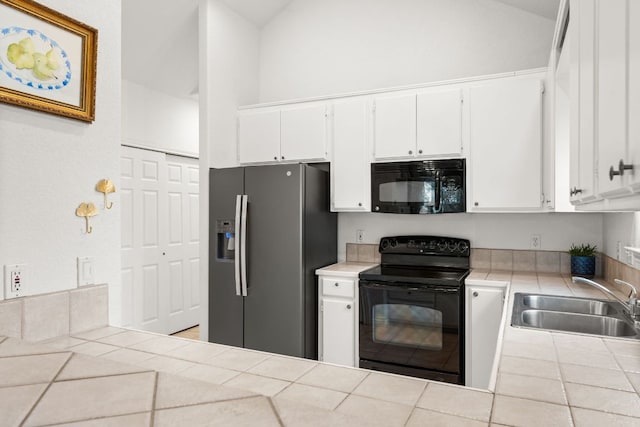 649 Aspen Ln, Cottonwood Shores, TX 78657 - kitchen with black appliances, tile counters, a sink, white cabinetry, and high vaulted ceiling