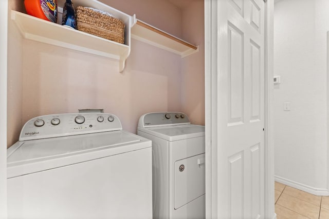 649 Aspen Ln, Cottonwood Shores, TX 78657 - laundry area featuring washer and dryer, light tile patterned floors, and baseboards