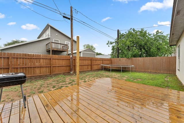 649 Aspen Ln, Cottonwood Shores, TX 78657 - wooden deck featuring a trampoline and a fenced backyard