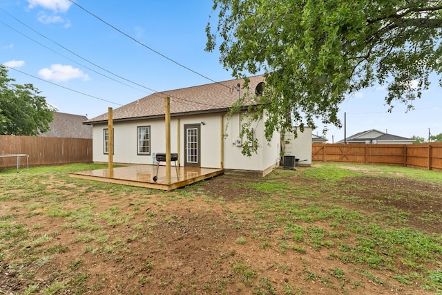 649 Aspen Ln, Cottonwood Shores, TX 78657 - back of property with a wooden deck, stucco siding, central AC unit, and a shingled roof