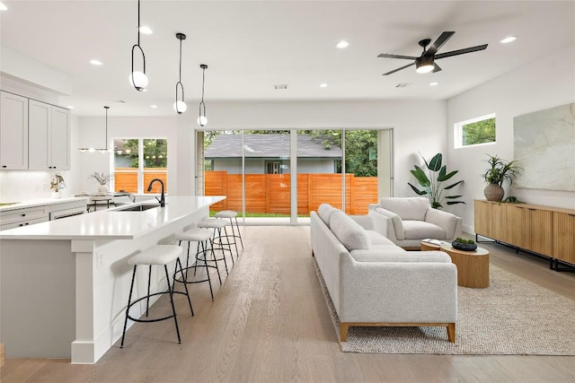 1702 Pennsylvania Ave, Austin, TX 78702 - living area with recessed lighting, healthy amount of natural light, light wood-style floors, and a ceiling fan