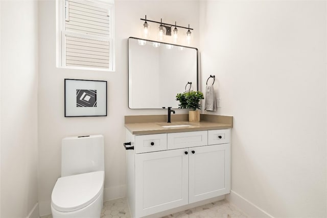 1702 Pennsylvania Ave, Austin, TX 78702 - bathroom with baseboards, toilet, and vanity