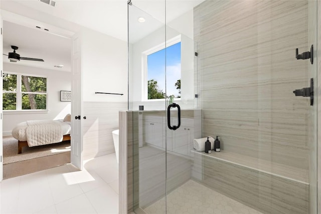 1702 Pennsylvania Ave, Austin, TX 78702 - ensuite bathroom with a shower stall, tile patterned floors, a soaking tub, tile walls, and a ceiling fan
