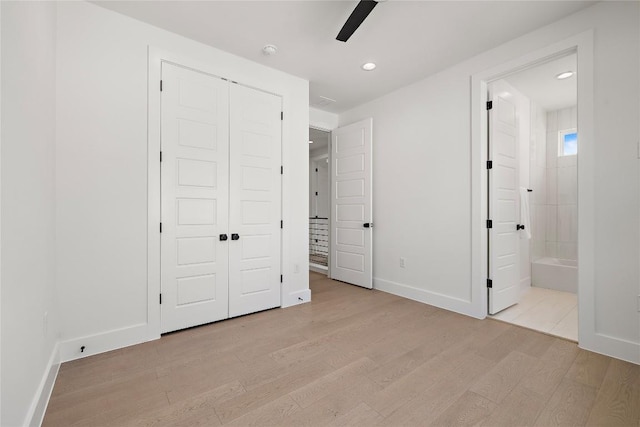 1702 Pennsylvania Ave, Austin, TX 78702 - unfurnished bedroom with light wood finished floors, baseboards, a closet, ensuite bath, and recessed lighting