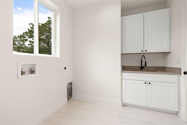 1702 Pennsylvania Ave, Austin, TX 78702 - laundry area with cabinet space, washer hookup, baseboards, electric dryer hookup, and light tile patterned floors