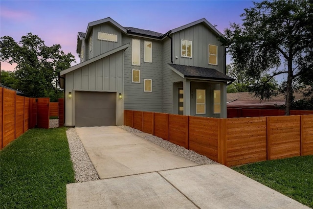 1702 Pennsylvania Ave, Austin, TX 78702 - contemporary home featuring board and batten siding, driveway, a fenced front yard, and roof with shingles