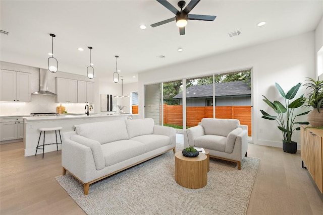 1702 Pennsylvania Ave, Austin, TX 78702 - living room featuring recessed lighting, light wood-type flooring, ceiling fan, and baseboards