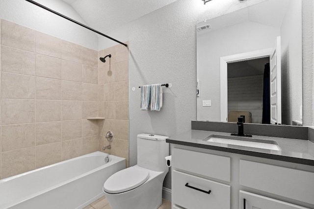 209 Northcrest Dr, Liberty Hill, TX 78642 - full bathroom with toilet, vanity, washtub / shower combination, a textured wall, and tile patterned flooring