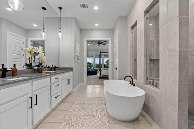 209 Northcrest Dr, Liberty Hill, TX 78642 - bathroom with connected bathroom, a ceiling fan, double vanity, a freestanding tub, and tile patterned floors