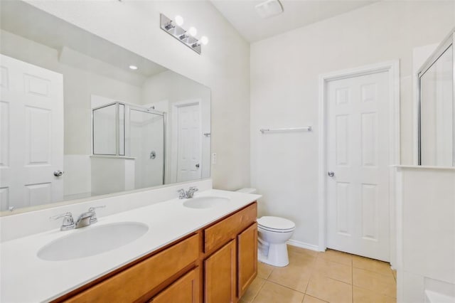 6900 Longford Trl, Austin, TX 78754 - bathroom featuring a stall shower, tile patterned floors, double vanity, and toilet