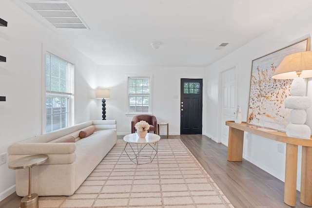 living room featuring wood finished floors and baseboards
