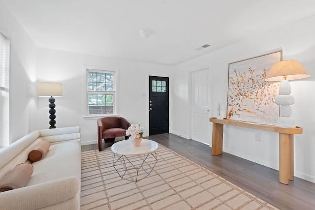living area featuring wood finished floors and baseboards