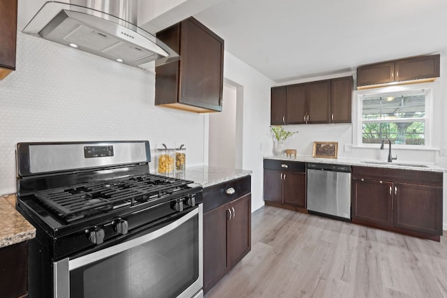 kitchen with stainless steel appliances, ventilation hood, a sink, light wood-type flooring, and dark brown cabinets