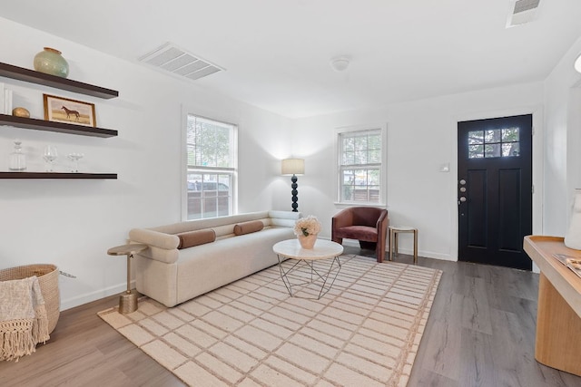 living area with wood finished floors and baseboards
