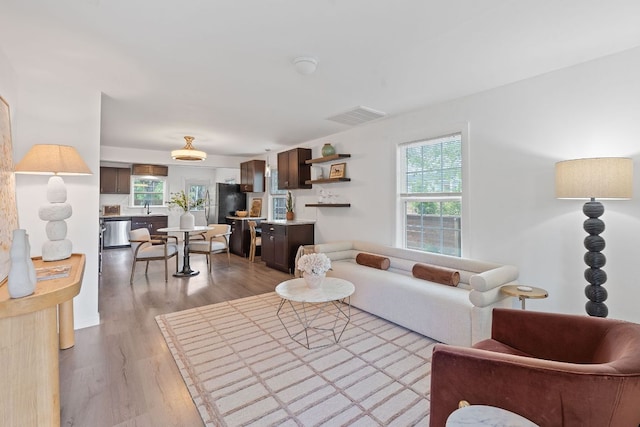 living area featuring healthy amount of natural light and light wood-type flooring