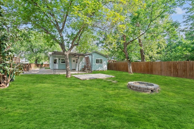 rear view of house featuring an outdoor fire pit and a patio area