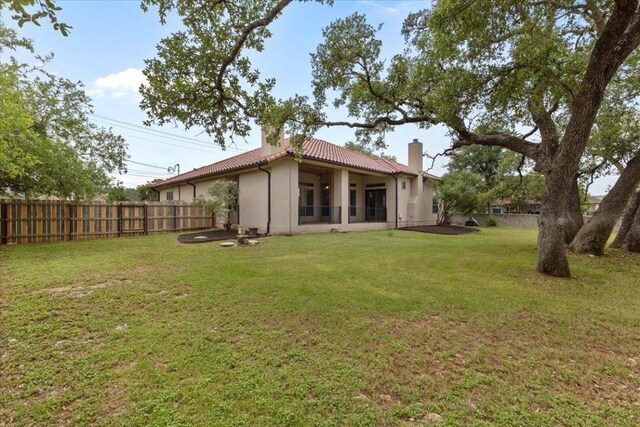 2450 Great Oaks Dr, San Marcos, TX 78666 - back of house with a chimney, a tiled roof, and stucco siding