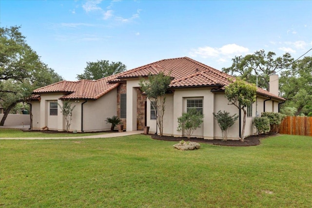 mediterranean / spanish home with stucco siding, a tile roof, and a chimney