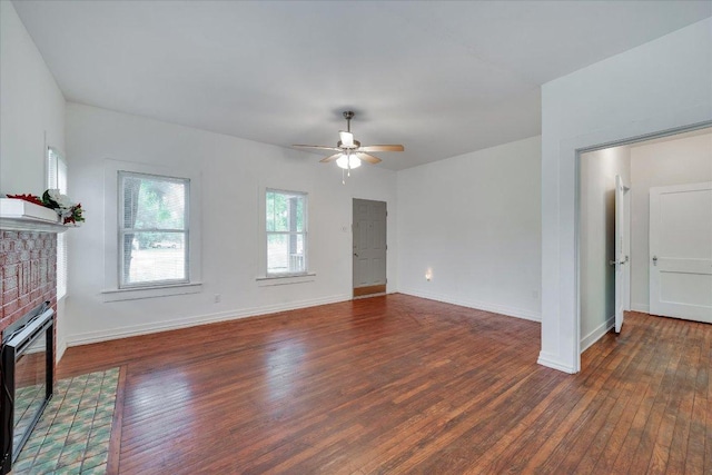 513 San Marcos Hwy, Luling, TX 78648 - unfurnished living room featuring wood finished floors, a ceiling fan, and a fireplace