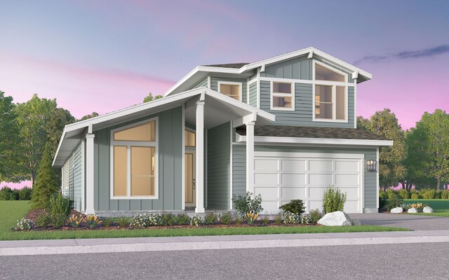 view of front of property with board and batten siding, a garage, and driveway