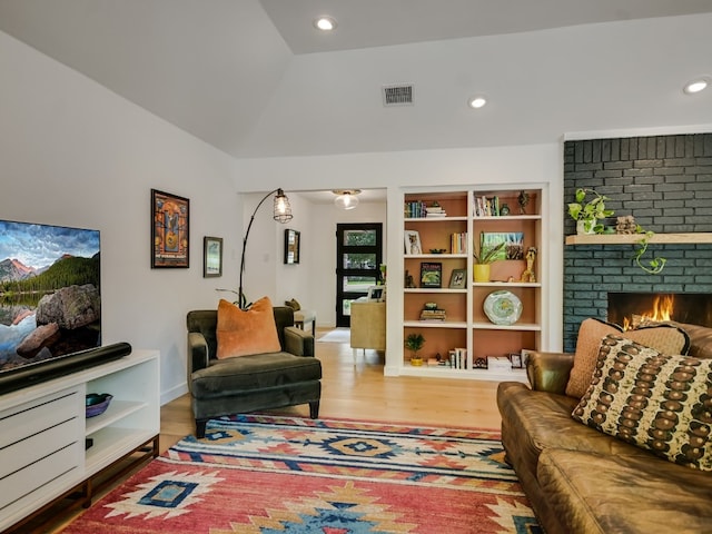 6802 Rio Bravo Ln, Austin, TX 78737 - living room featuring a brick fireplace, wood finished floors, recessed lighting, and lofted ceiling