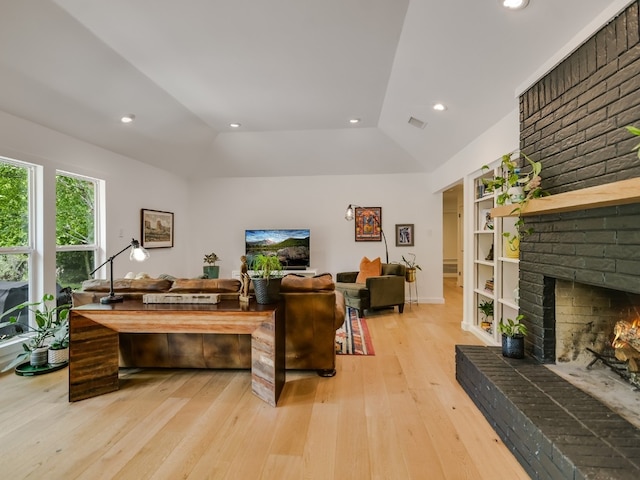 6802 Rio Bravo Ln, Austin, TX 78737 - living room featuring light wood-style floors, a brick fireplace, vaulted ceiling, recessed lighting, and built in features