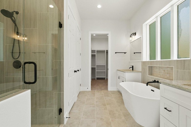 20405 Sunset Strip St, Lago Vista, TX 78645 - bathroom featuring a shower stall, vanity, a freestanding tub, recessed lighting, and tile patterned floors