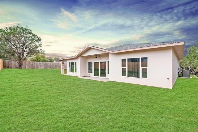 20405 Sunset Strip St, Lago Vista, TX 78645 - rear view of house with a ceiling fan, stucco siding, and a patio area