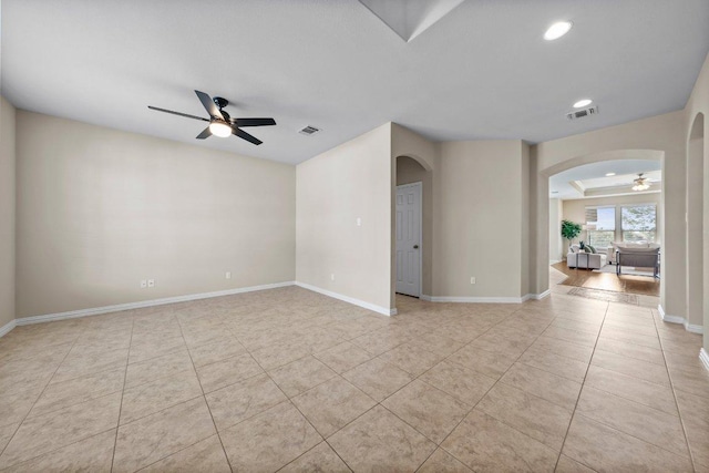 2020 Elaina Loop, Leander, TX 78641 - empty room with a ceiling fan, arched walkways, light tile patterned flooring, recessed lighting, and baseboards