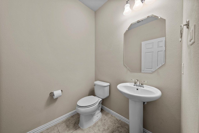 2020 Elaina Loop, Leander, TX 78641 - half bathroom featuring toilet, tile patterned floors, a sink, and baseboards