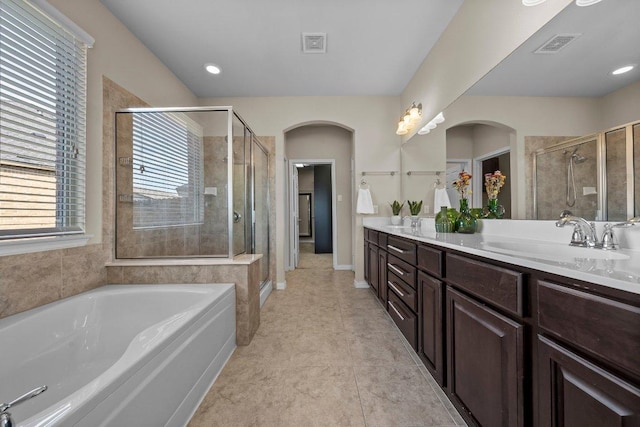 2020 Elaina Loop, Leander, TX 78641 - bathroom with a shower stall, double vanity, a garden tub, and tile patterned flooring