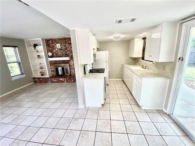 8502 Woodstone Dr, Austin, TX 78757 - kitchen featuring light countertops, built in features, light tile patterned floors, and plenty of natural light