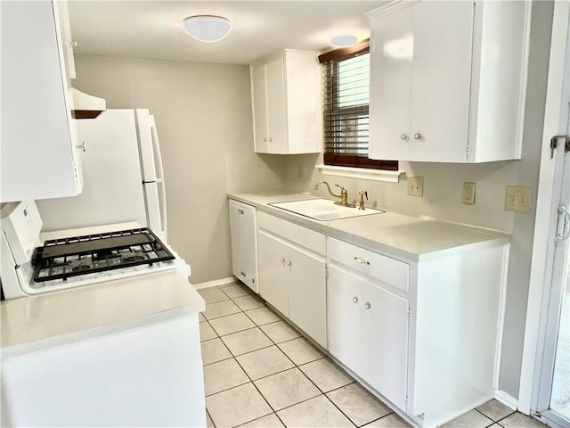 8502 Woodstone Dr, Austin, TX 78757 - kitchen with a sink, white appliances, light countertops, light tile patterned floors, and white cabinets