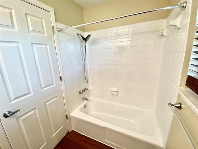 8502 Woodstone Dr, Austin, TX 78757 - bathroom with shower / washtub combination and wood finished floors