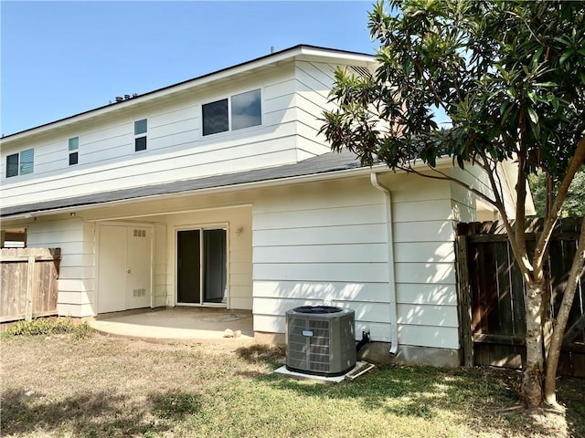 8502 Woodstone Dr, Austin, TX 78757 - rear view of property with central AC unit, fence, and a patio