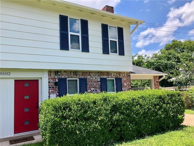 8502 Woodstone Dr, Austin, TX 78757 - view of front facade with a chimney and brick siding