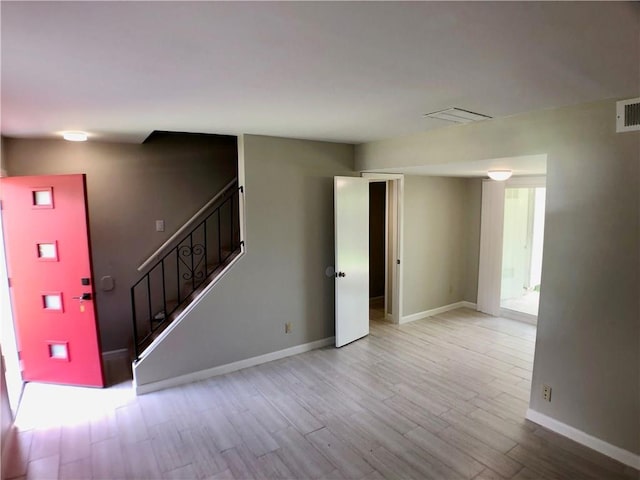 8502 Woodstone Dr, Austin, TX 78757 - unfurnished living room featuring light wood-style flooring, stairway, and baseboards