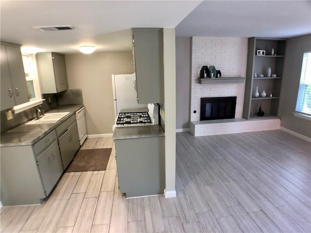 8502 Woodstone Dr, Austin, TX 78757 - kitchen with a sink, gray cabinets, white appliances, and light wood-type flooring
