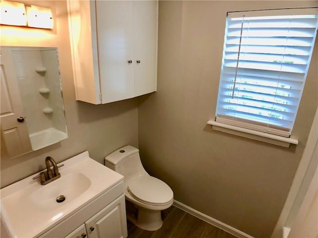 8502 Woodstone Dr, Austin, TX 78757 - bathroom featuring wood finished floors, toilet, baseboards, and vanity