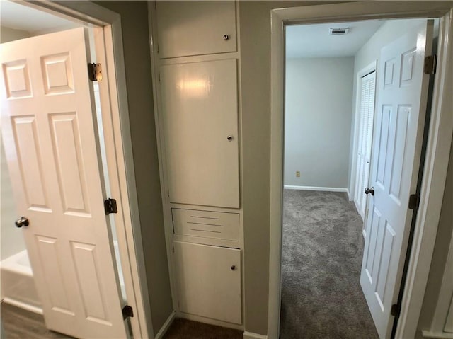 8502 Woodstone Dr, Austin, TX 78757 - corridor with dark carpet and baseboards
